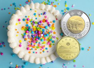 Canada Loonie and Toonie coins with cake - Littleton Coin Blog