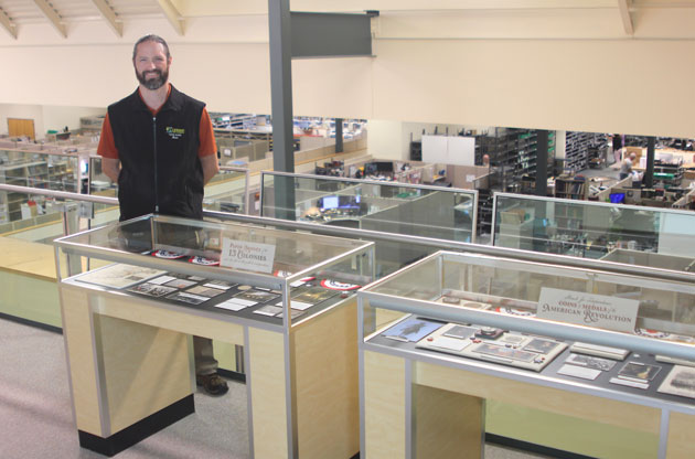 Tour guide with display - Littleton Coin Blog